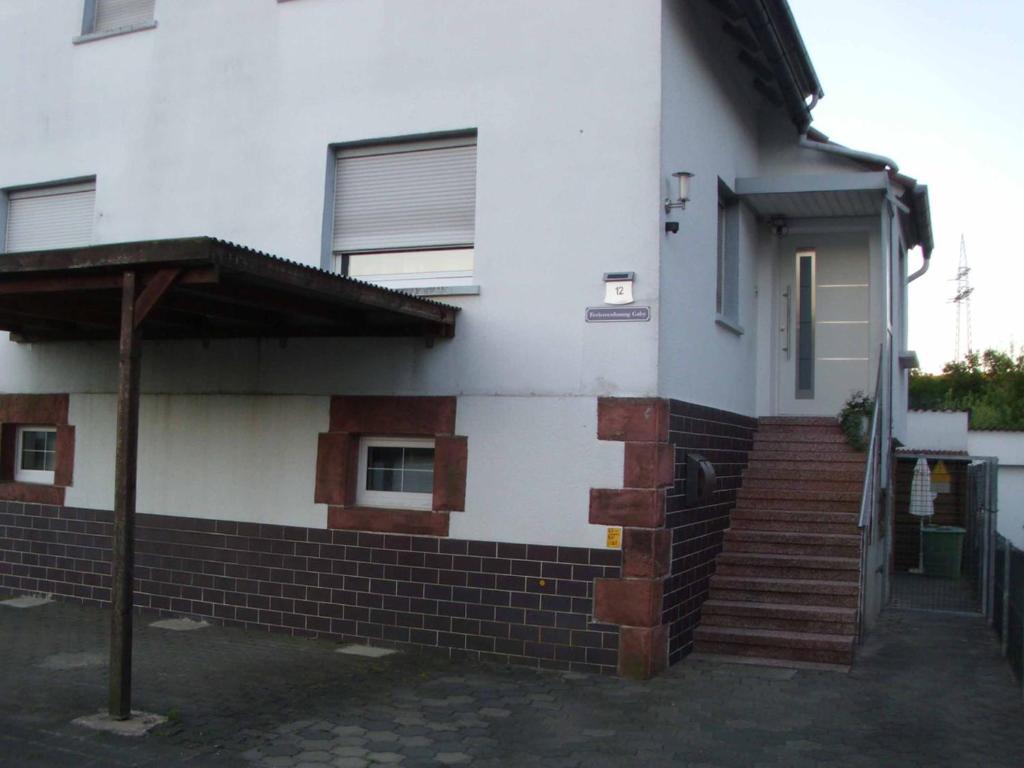 a house with a brick staircase leading to a door at Ferienwohnung Gaby in Marburg an der Lahn