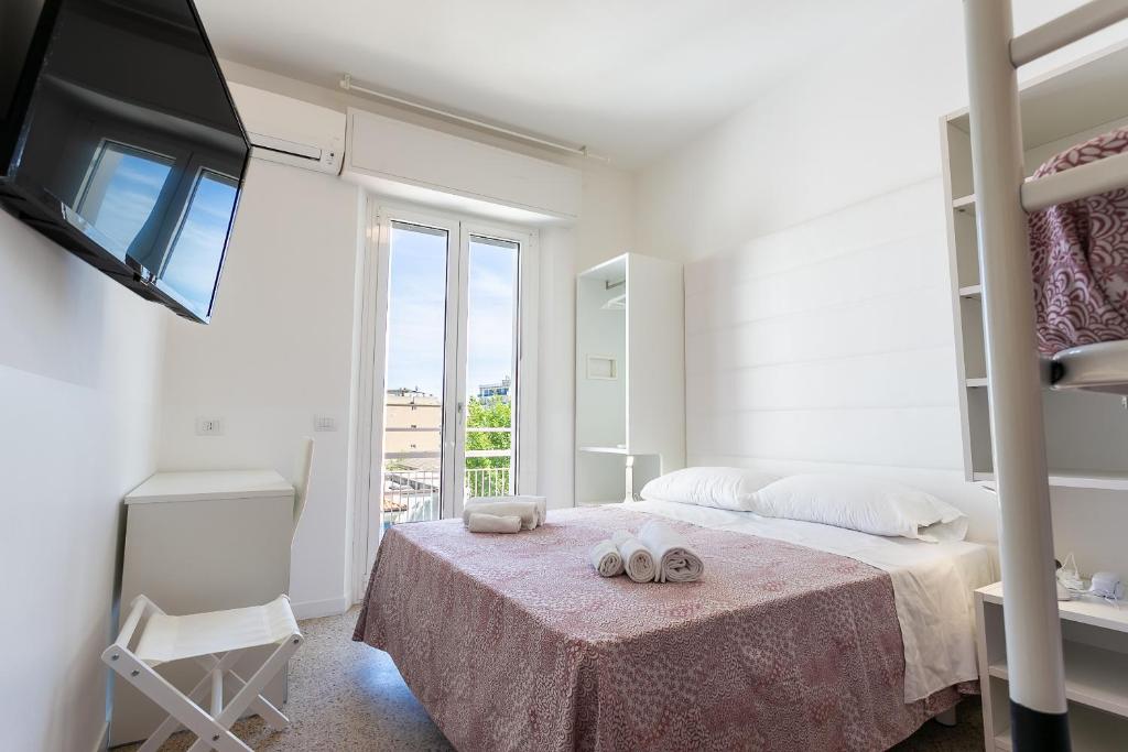 Postel nebo postele na pokoji v ubytování Hotel Ninfea Cattolica