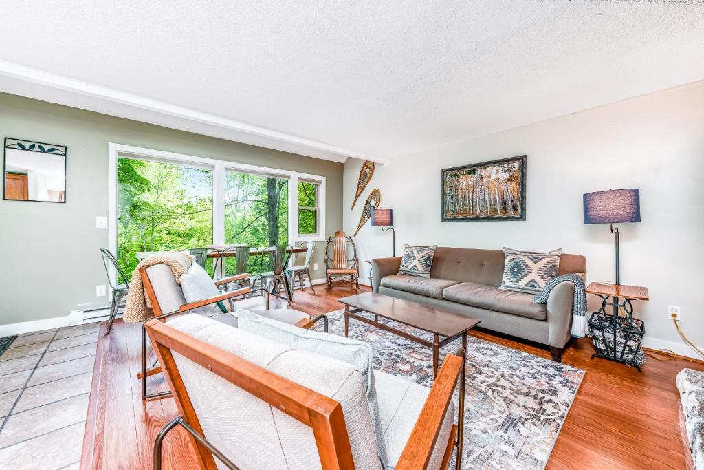 a living room with a couch and a table at The Hemlock Hideaway in Sugar Mountain