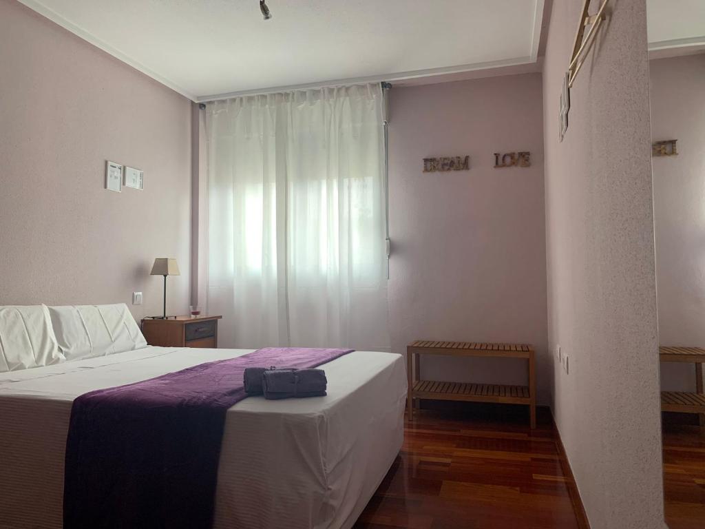 a bedroom with a bed with a suitcase on it at Apartamento Classic OscVict en El Palmar, Murcia. in Murcia
