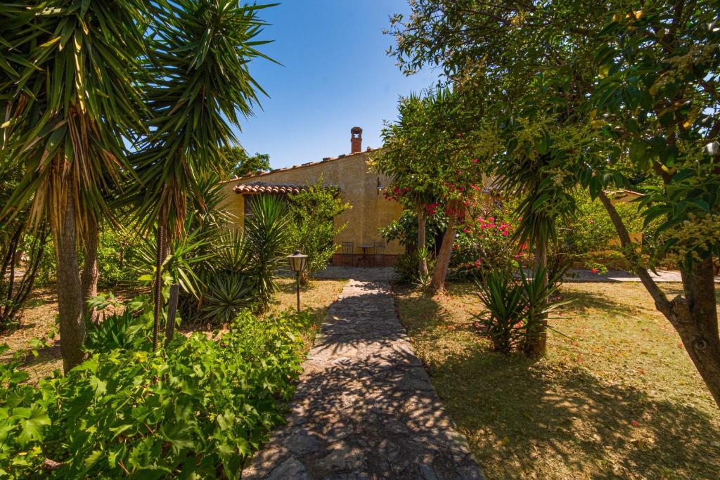 a house in the middle of a yard with trees at Villa Fratantoni Piana - Villa privata con accesso diretto alla spiaggia in Caronia Marina