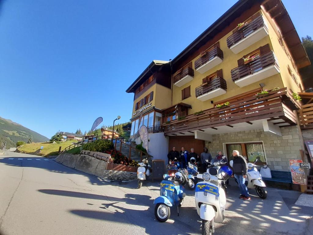 a group of scooters parked outside of a building at Confinale in Santa Caterina Valfurva