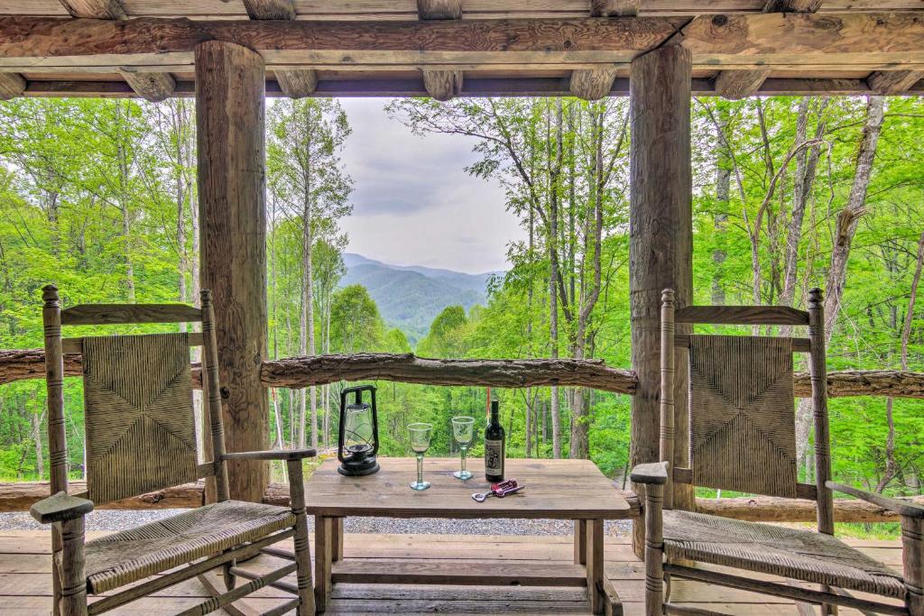 a table and chairs on a porch with a view at Secluded Cabin with Porch on 39 Acres Ski and Hike in Swiss