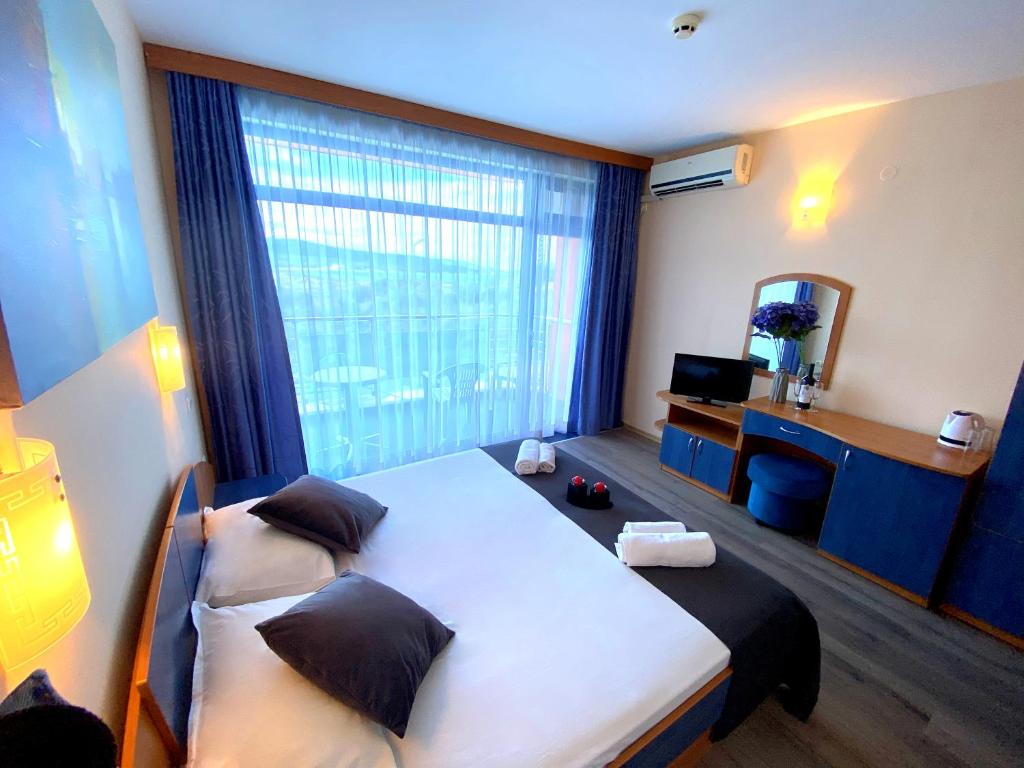 Postel nebo postele na pokoji v ubytování Hotel Penelope