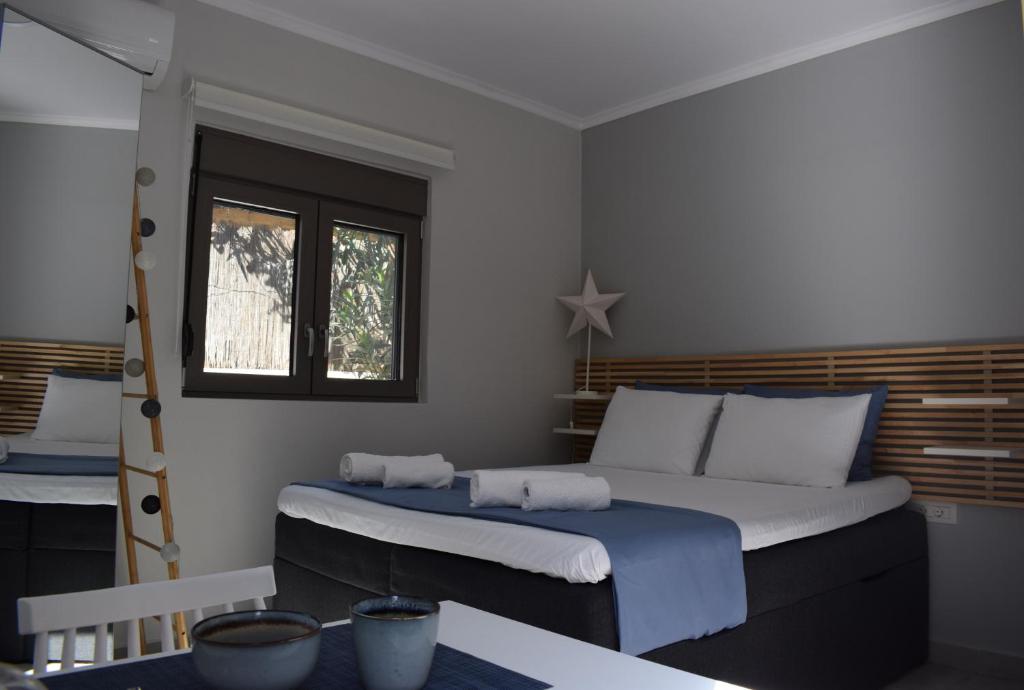 a bedroom with a large bed and a window at Antigonis Garden House in Chania