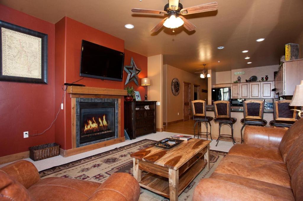 a living room with a couch and a fireplace at Peregrine Point 103 in Durango Mountain Resort