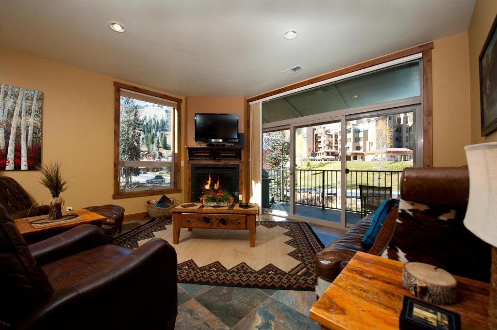 a living room with a couch and a fireplace at Peregrine Point 201 in Durango Mountain Resort