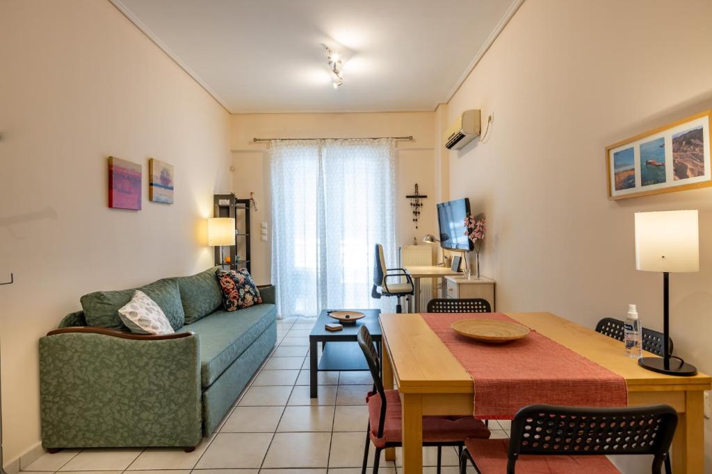 a living room with a couch and a table at Flat in excellent location with private parking in Athens