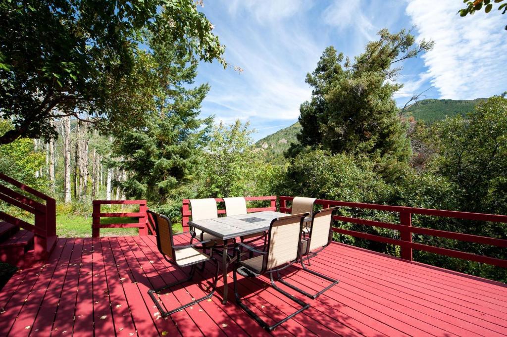 a wooden deck with a table and chairs on it at 3830 County Road 124 in Hesperus