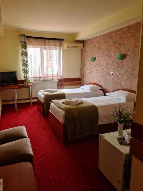 Postel nebo postele na pokoji v ubytování Hotel Olimp