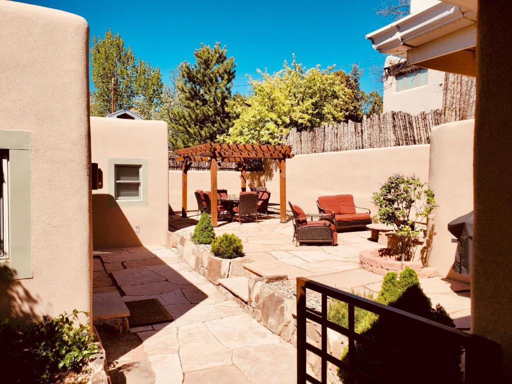 a patio with chairs and a gazebo at 101 Llano Largo in Santa Fe
