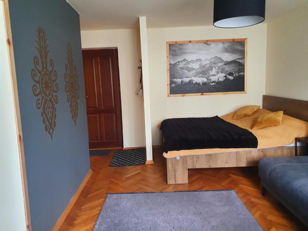 Posteľ alebo postele v izbe v ubytovaní Apartament IZBA W CENTRUM
