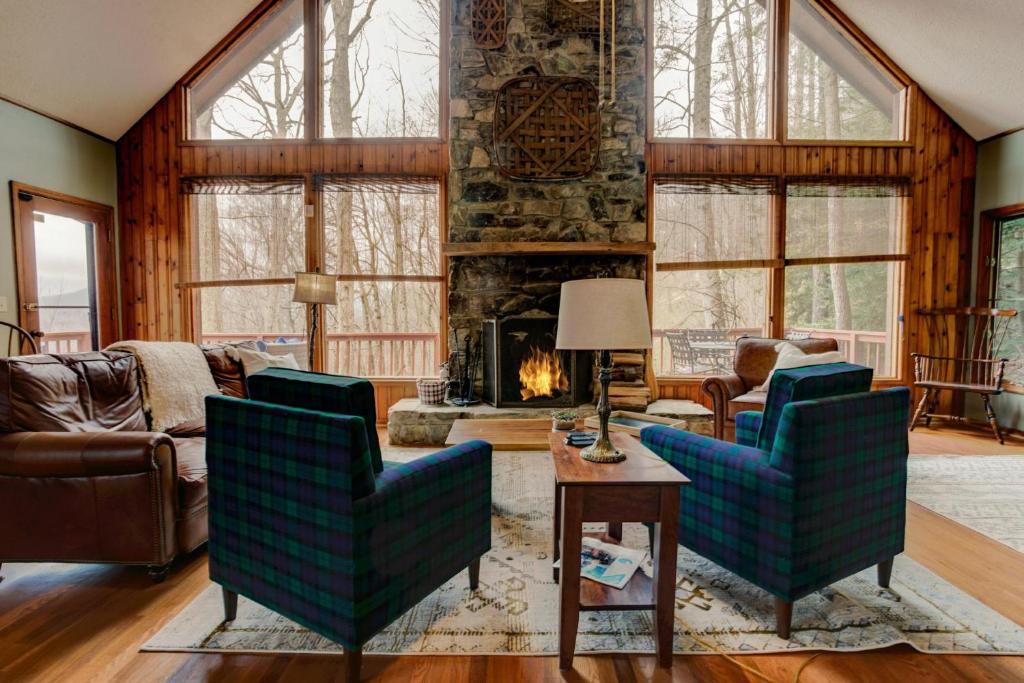 a living room with two chairs and a fireplace at Lanfyne Ayr in Waynesville