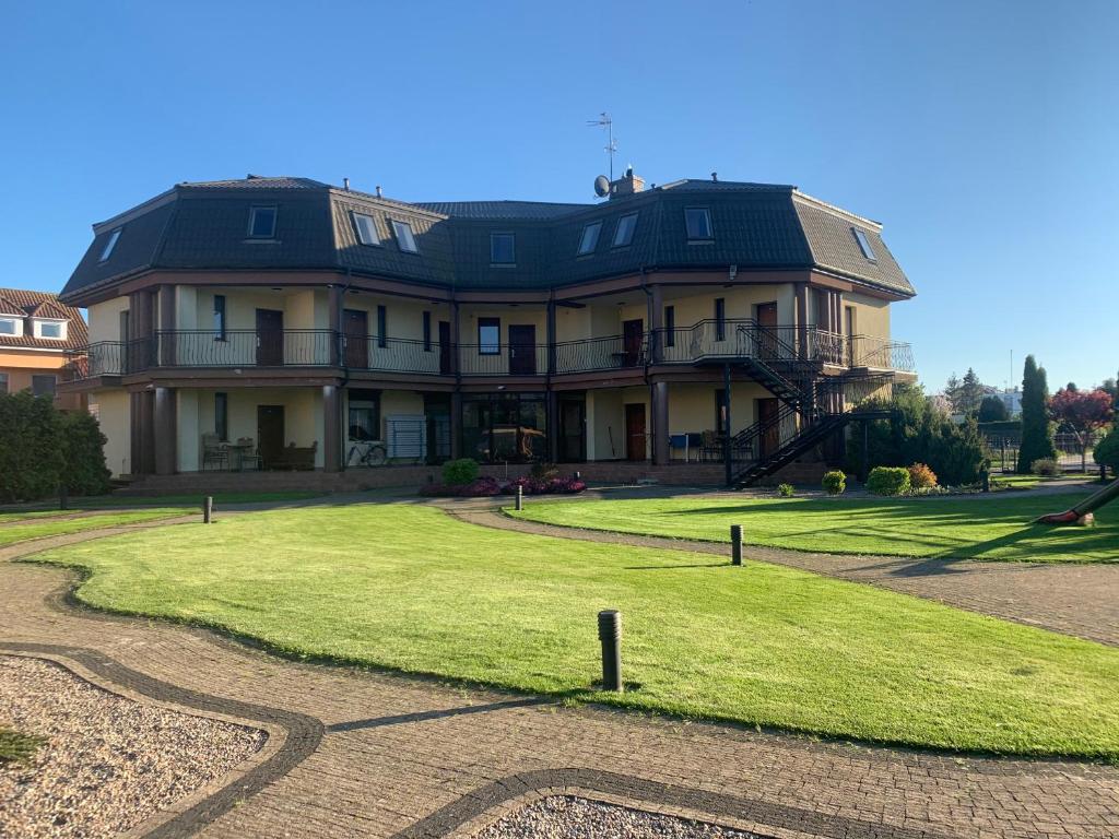 a large house sitting on top of a lush green field at Villa Aida in Mielno