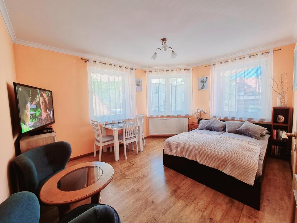 a bedroom with a bed and a table and chairs at Mieszkanie Nad Morzem in Ustka