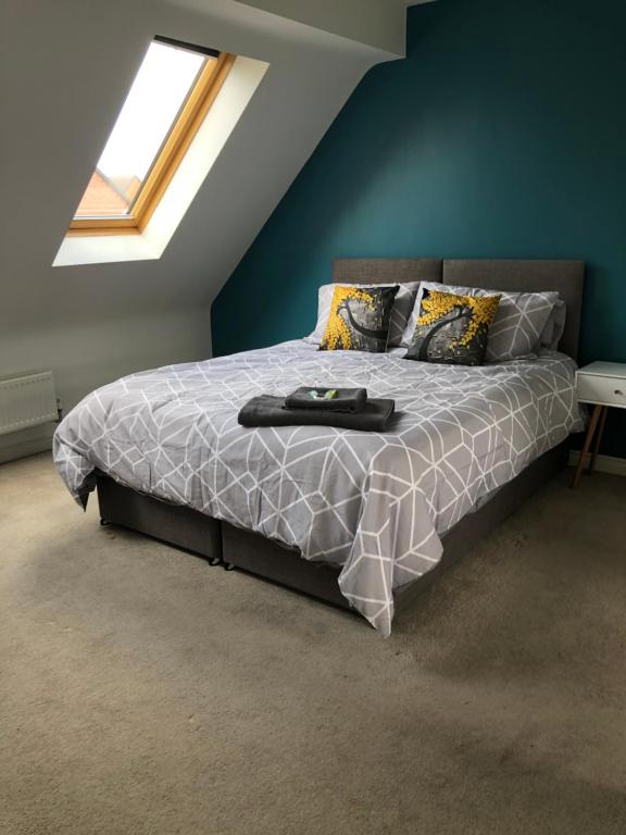 een slaapkamer met een groot bed en een raam bij Spring House - Staycation - Perfect for Contractors & Families - 2 Parking Spaces in Dudley