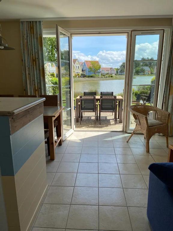 a living room with a view of the water at Pepper Lake in Fort-Mahon-Plage