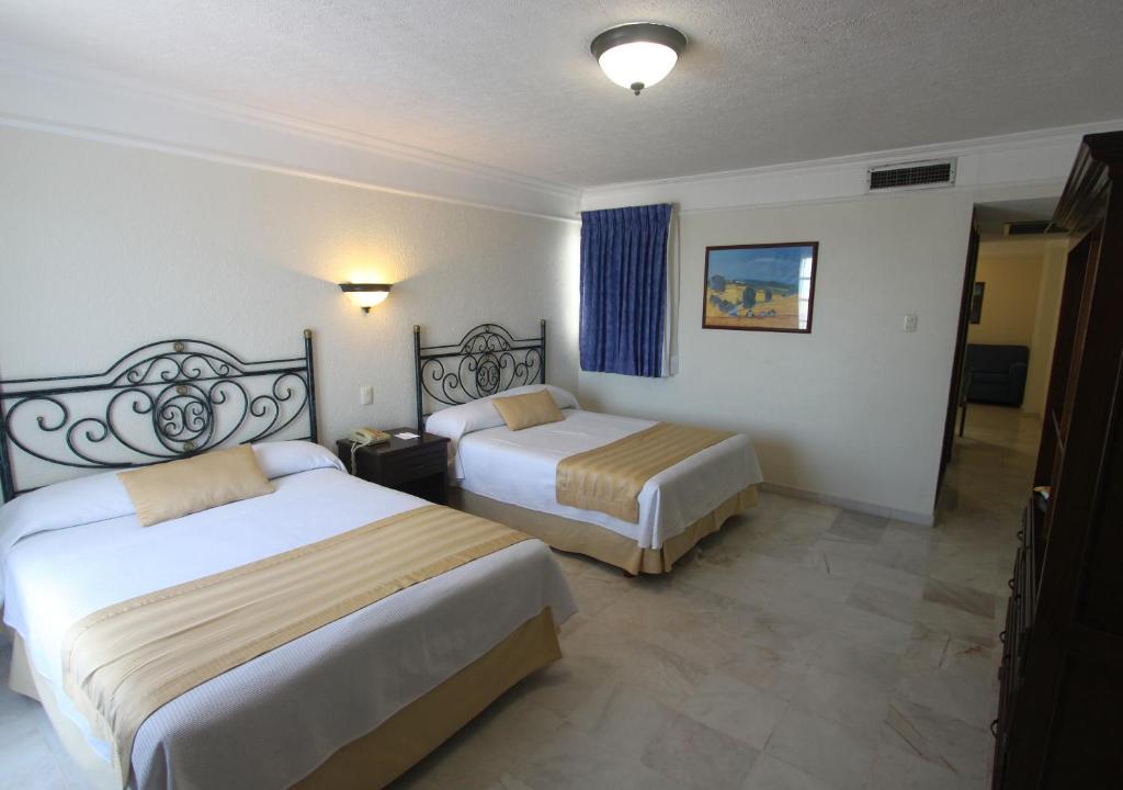 Postel nebo postele na pokoji v ubytování Hotel Francis Drake
