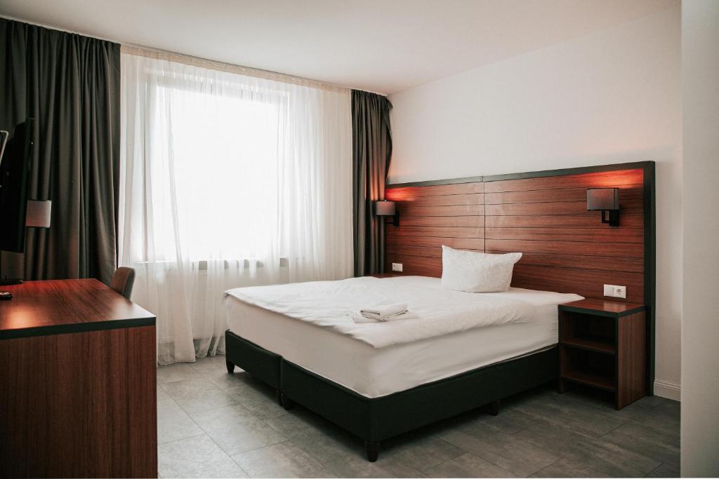 a bedroom with a large bed with a wooden headboard at Domizil in Bremen