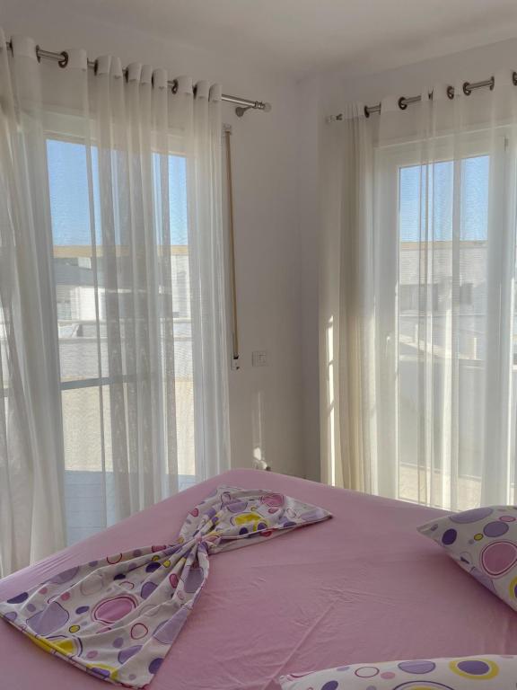 Postel nebo postele na pokoji v ubytování Nimfeum Apartments