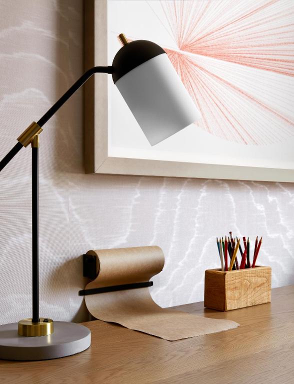 a desk with a lamp and a picture on the wall at Saint Kate - The Arts Hotel in Milwaukee