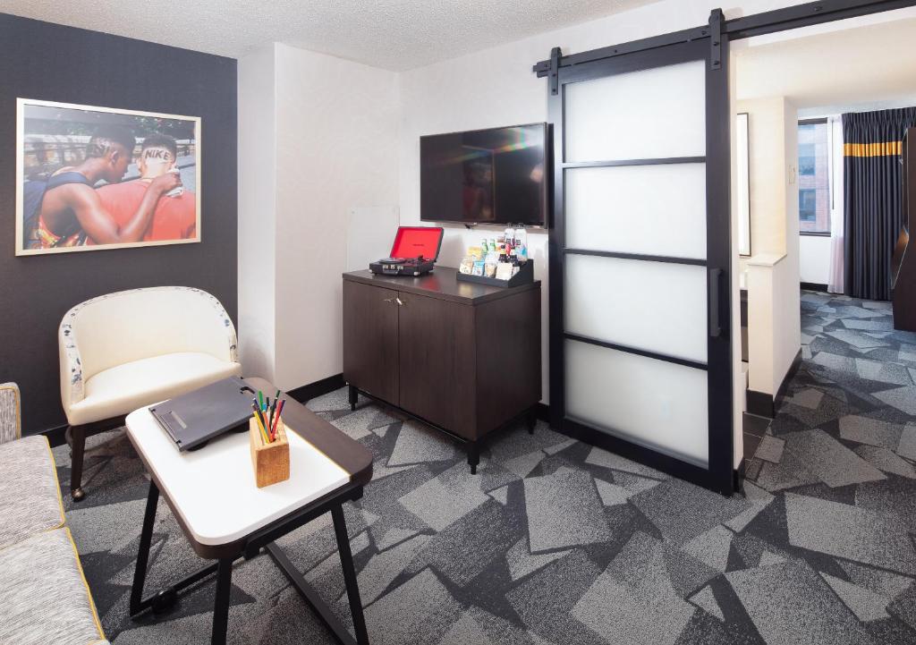 a room with a desk and a sliding door at Saint Kate - The Arts Hotel in Milwaukee
