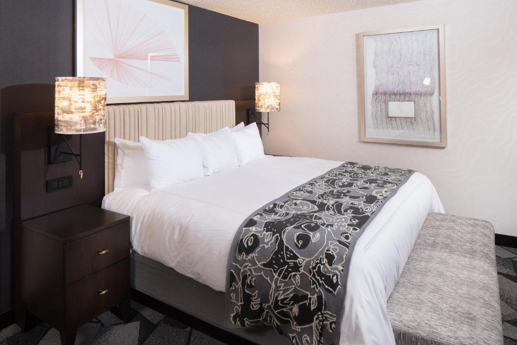 a hotel room with a bed with a black and white blanket at Saint Kate - The Arts Hotel in Milwaukee