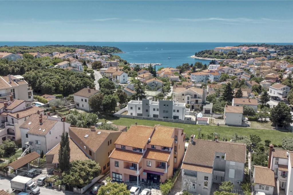 an aerial view of a town with houses and the ocean at Holiday Home & Apartments Primavera in Pula
