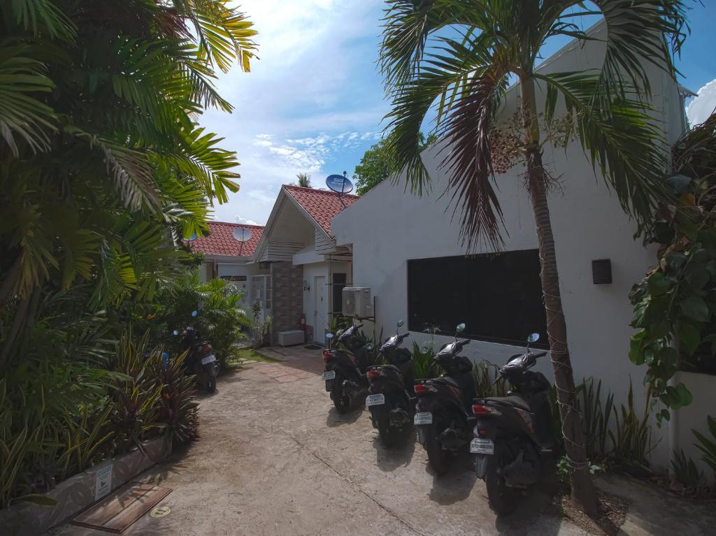 motorcycles parked in front of a building at Vaccinated Staff - OYO 771 Darius' Residences in Moalboal