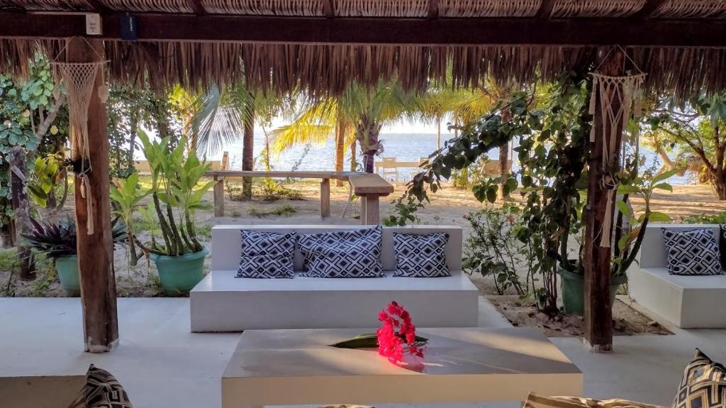 a pavilion with white benches and a view of the beach at Oceano Atins in Atins