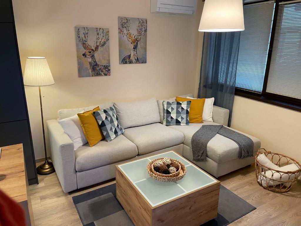 a living room with a couch and a coffee table at Your Place Apartment in Varna City