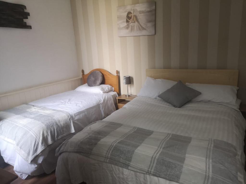 two beds sitting next to each other in a bedroom at the belvere in Blackpool