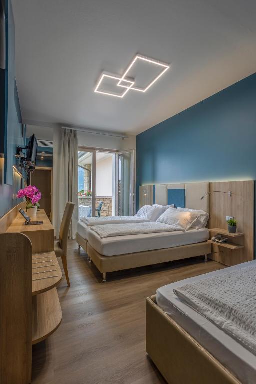 Postel nebo postele na pokoji v ubytování Hotel Veronesi