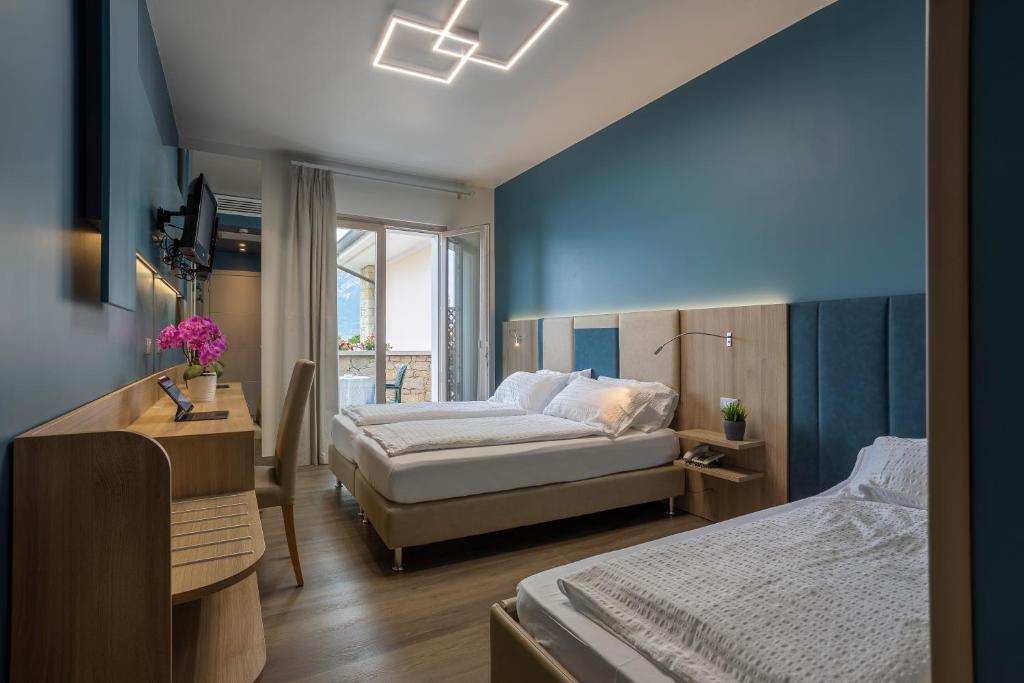 Postel nebo postele na pokoji v ubytování Hotel Veronesi