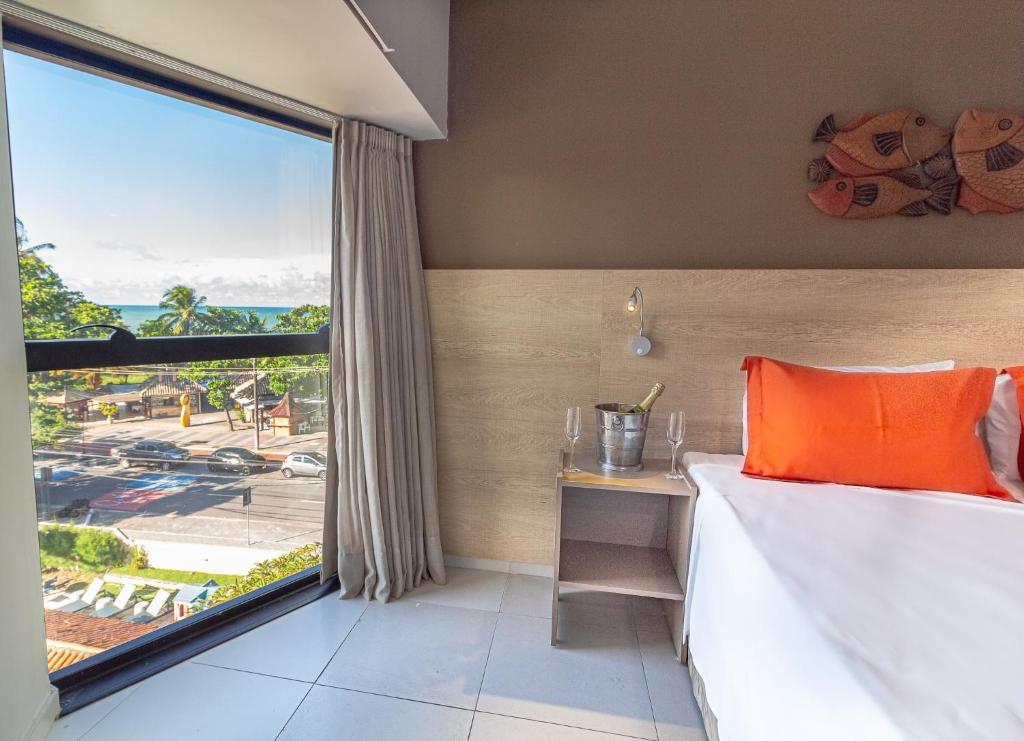 Cama ou camas em um quarto em Littoral Hotel