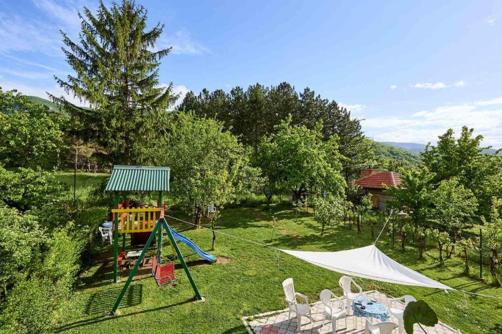 a backyard with a swing set and a playground at Apartmani Stanojevic Sokobanja in Soko Banja