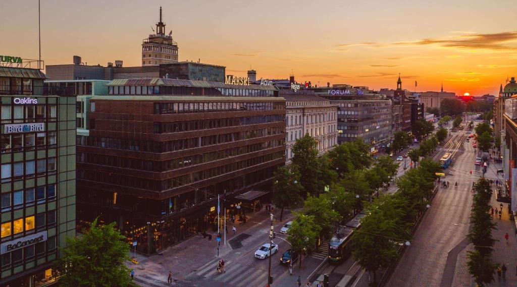 a view of a city with a street at sunset at Marski by Scandic in Helsinki
