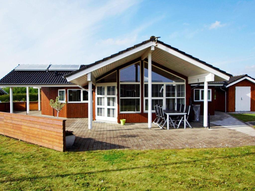 a detached house with a deck and a patio at 6 person holiday home in Hemmet in Hemmet