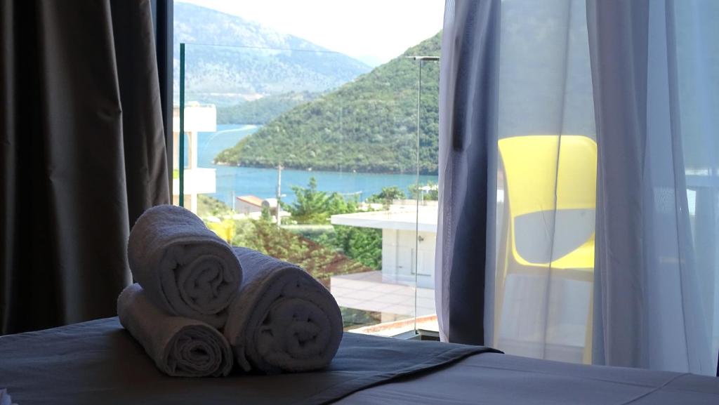 a room with a bed with a view of a mountain at Valmar Hotel in Ksamil