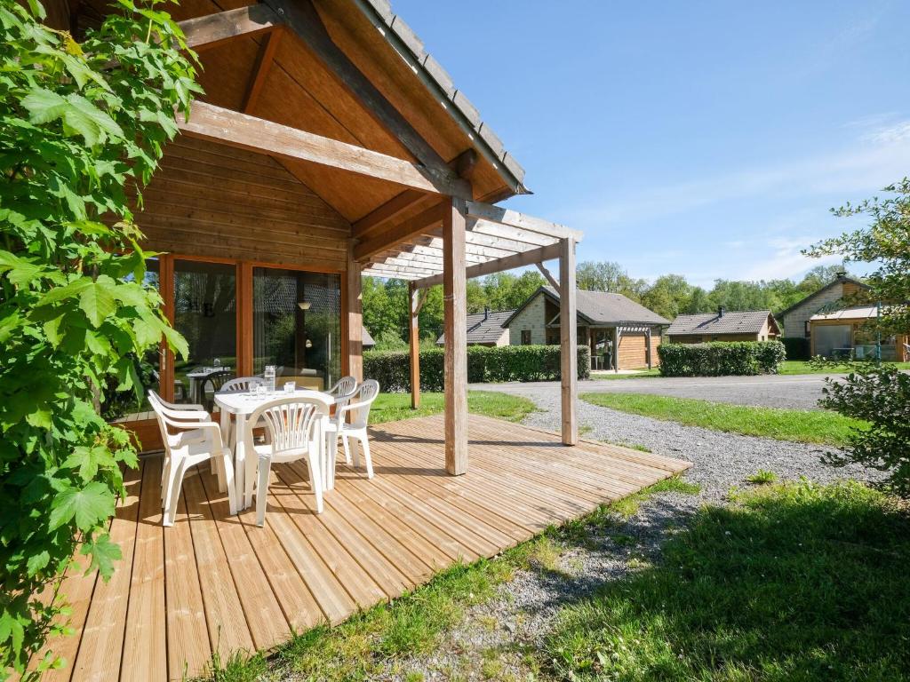 a wooden deck with a table and chairs on it at Comfortable holiday home with private terrace in Signy-le-Petit