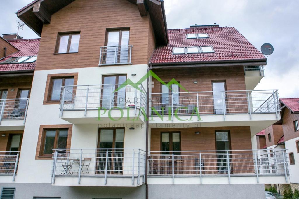 a building with balconies on the side of it at Sudety Park - PolanicaApartamenty pl in Polanica-Zdrój