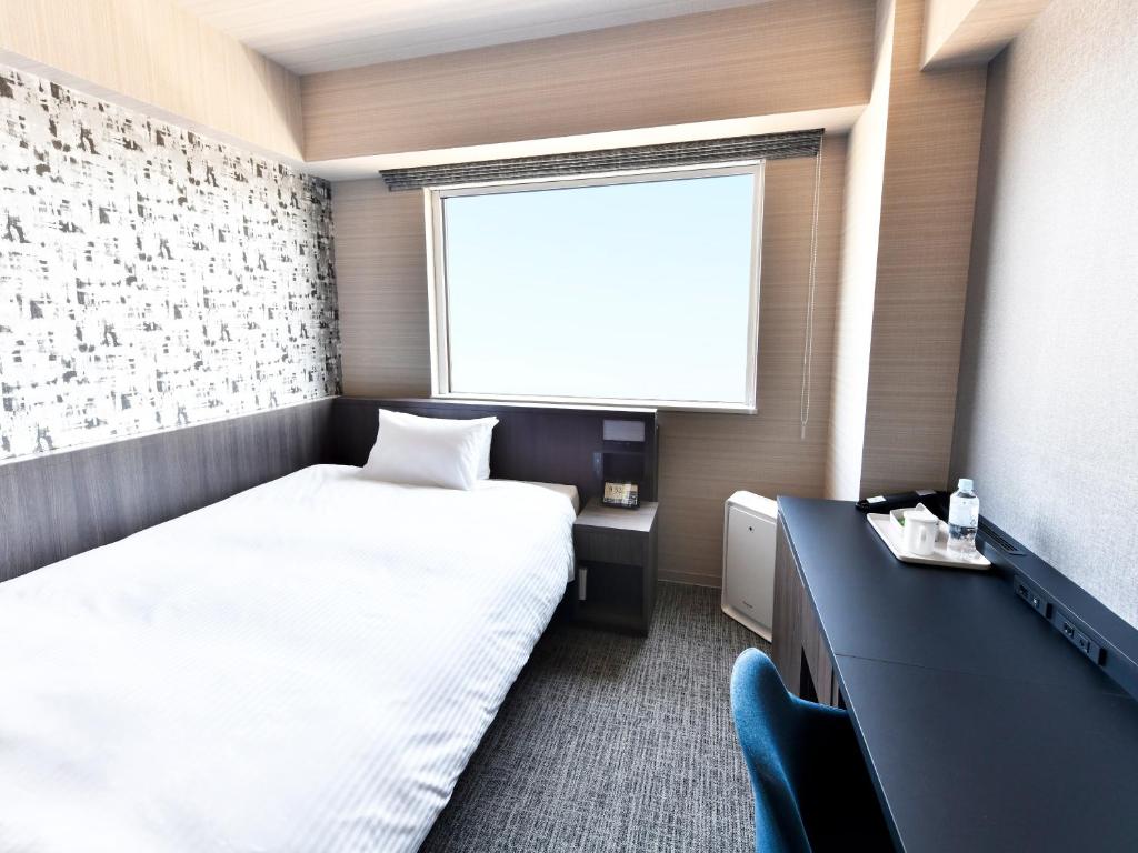 Postel nebo postele na pokoji v ubytování Wakoshi Tobu Hotel