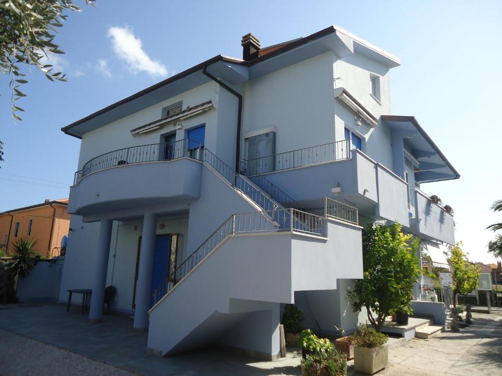 a white building with stairs on it at Casa Meris in Fano