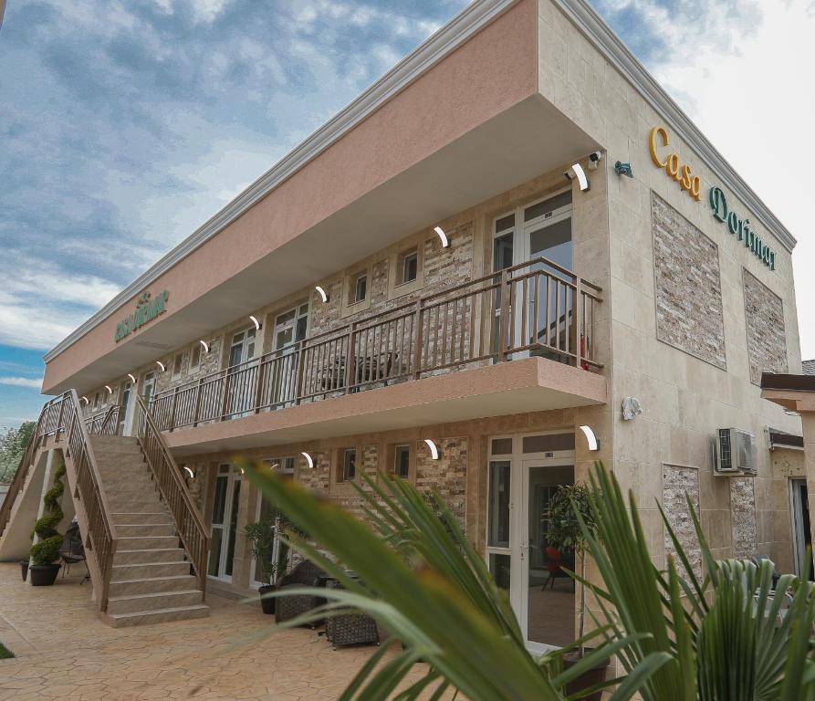 a building with a staircase on the side of it at Vila Dorimar Mamaia Nord in Mamaia Sat/Năvodari