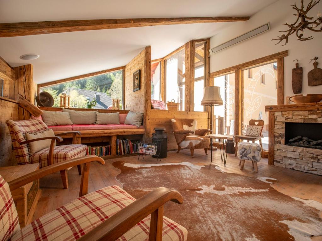 a living room with a couch and a fireplace at Berghi Hotel and Apartments in Kranjska Gora