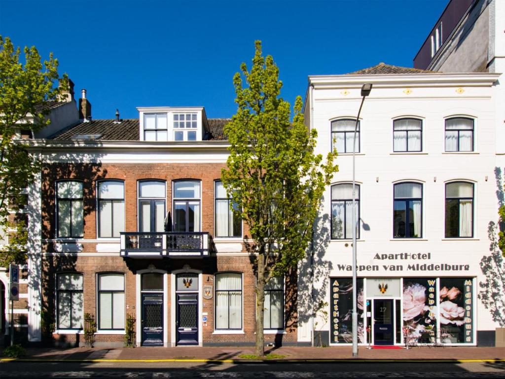 a large building with a clock on the front of it at ApartHotel Waepen van Middelburg in Middelburg