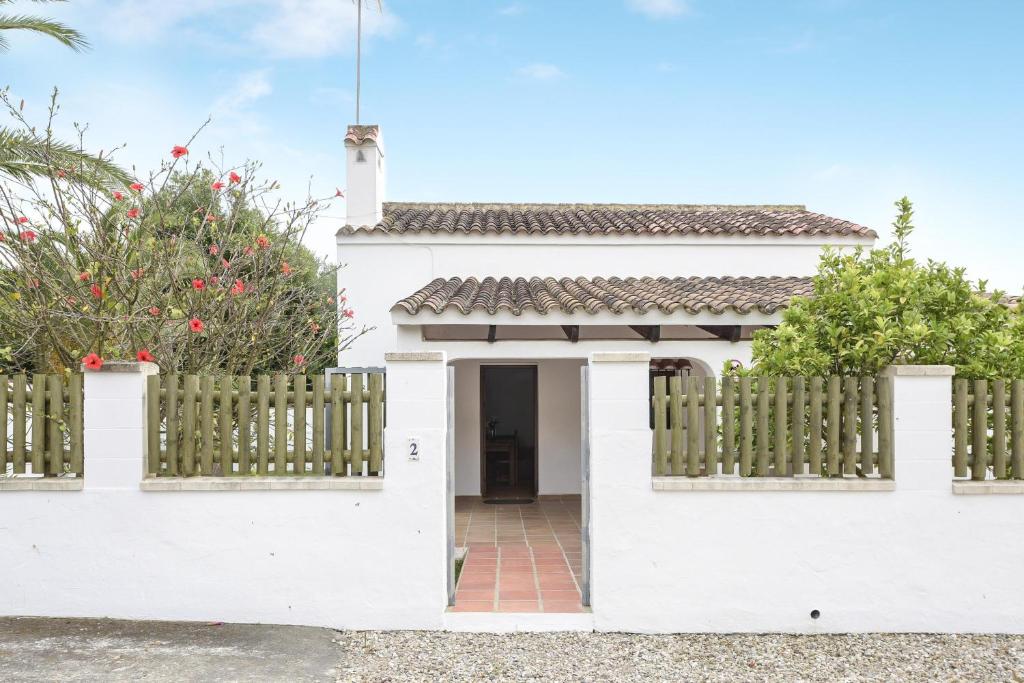 a white house with a gate and a fence at Casa Miguelin in Zahora