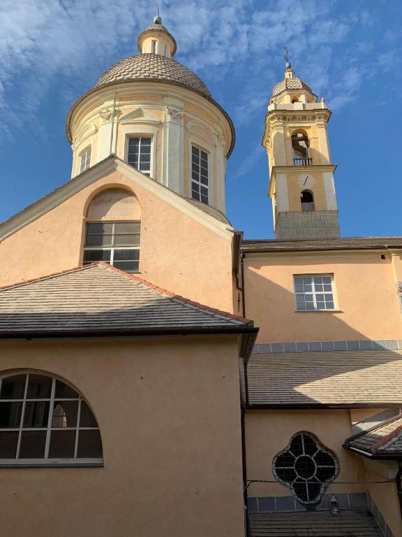 a building with a clock tower on top of it at Casa Entella by Vacanze in Chiavari in Chiavari