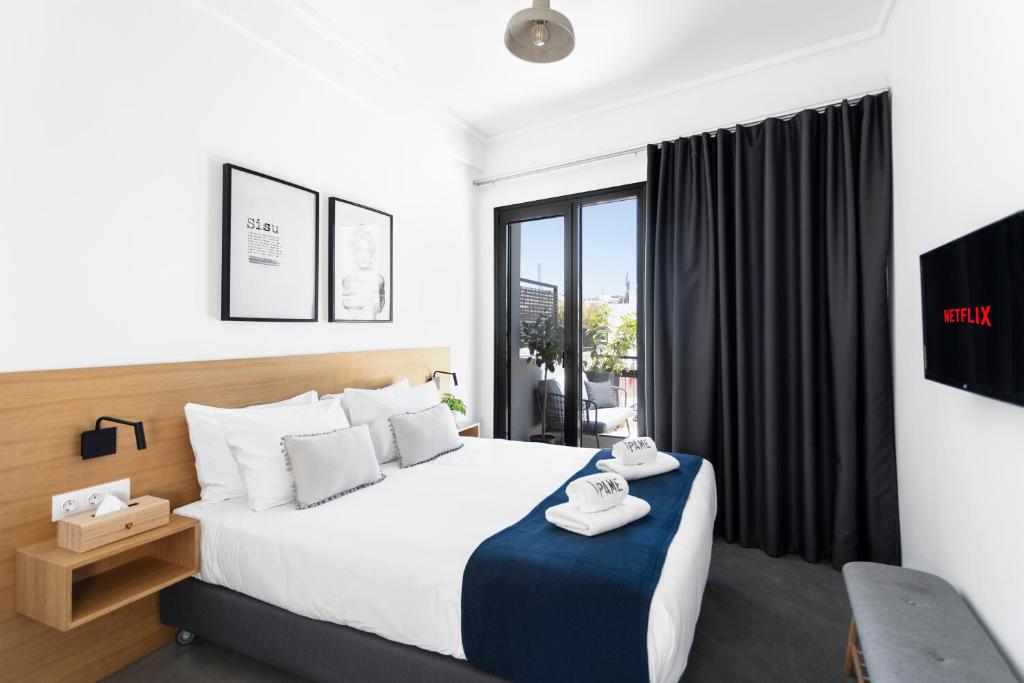 a bedroom with a bed and a large window at PAME House in Athens