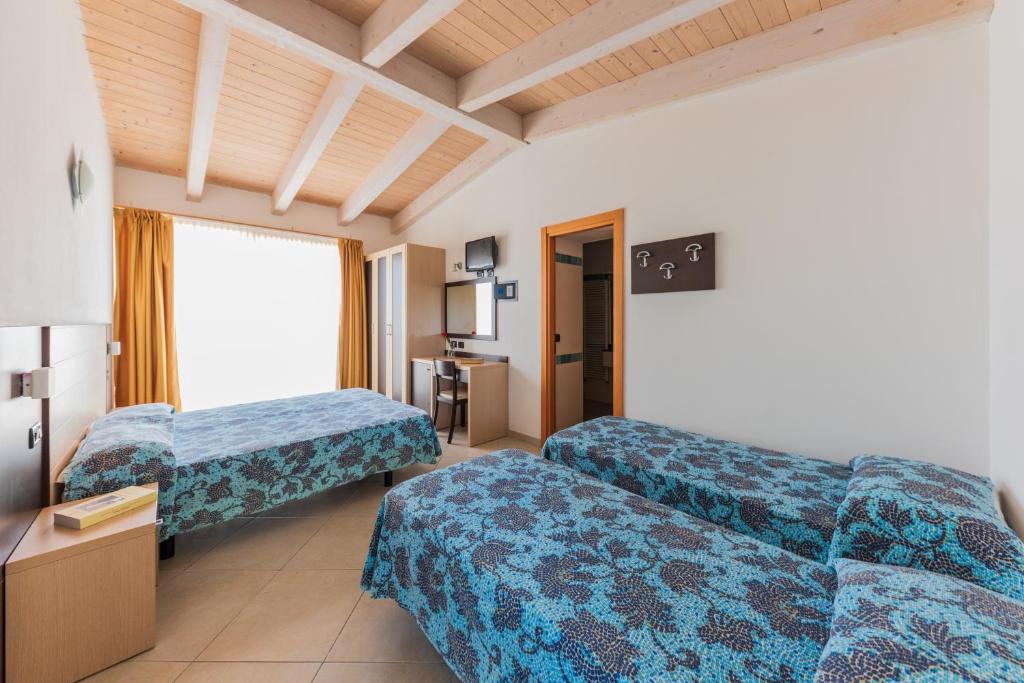 A bed or beds in a room at Residence Renadoro